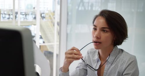 Businesswoman working on computer at desk in office