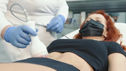 Woman Receiving Abdomen Medical Procedure in Clinic