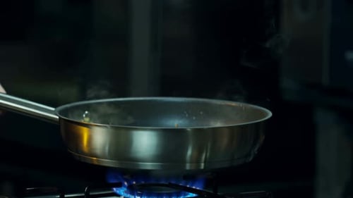 Frying Pan on Gas Range with Rising Steam