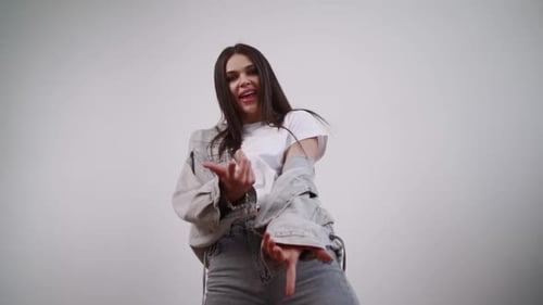Young Woman Dancing Fashionably in Studio Setting