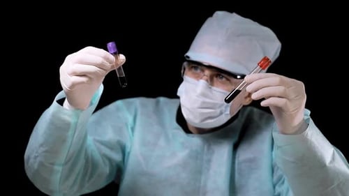 Medical Professional Holding Two Test Tubes in Lab