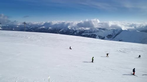 Majestic Aerial View of Skiers on Snowy Mountain