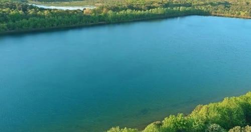 Aerial view of natural pond on a sunny summer day forest panorama