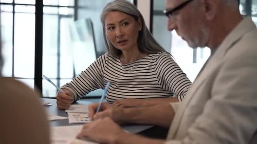 Team Members Collaborate on a Project in Office
