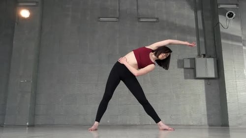 Woman Stretching in Urban Studio