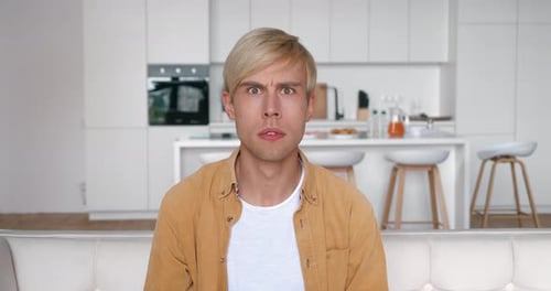 Man Reacts in Shock in Modern Home Setting