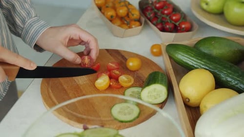 Slicing Tomatoes for Colorful Healthy Salad at Home