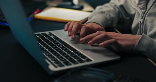 Young Boy Does Homework Scrolls on Laptop Works on Computer Prepares Document School Project Child