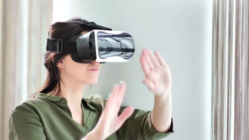 Woman Wearing VR Headset Interacting with Technology