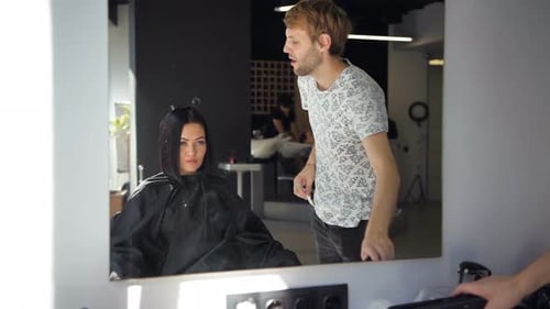 Hairdresser Straightens Woman's Hair in Salon