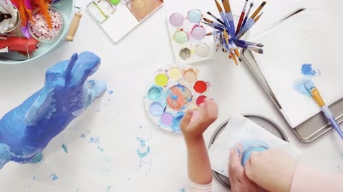 Time lapse. Step by step. Mother and daughter decorating paper mache unicorn together