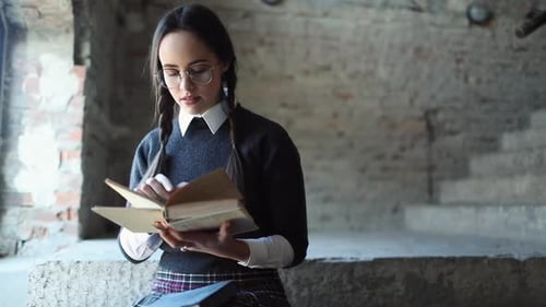 Young Woman Reads and Writes in Old Book