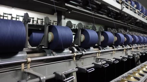 Thread Reels Rotating on Industrial Textile Machine