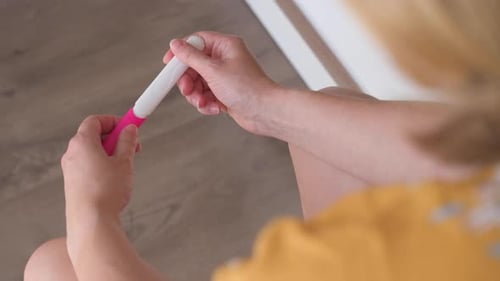 Woman Making Pregnancy Test in Bathroom