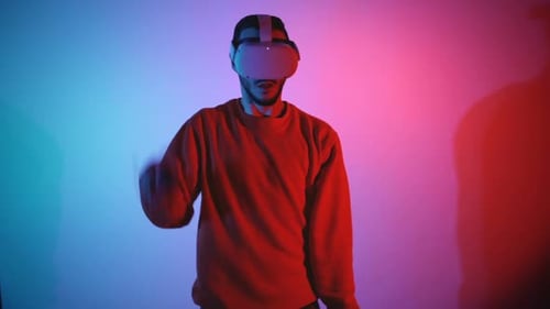 Young Adult Uses Virtual Reality Headset with Controllers