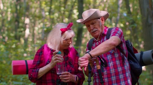 Active Senior Couple Taking Forest Hike