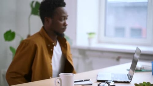 African Man Typing on Laptop at Home Office Spbas