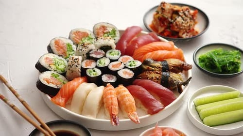 Various Sushi Rolls Placed on Round Ceramic Plate
