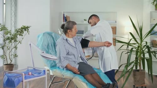 A Doctor Measures the Blood Pressure of an Elderly Patient in a Hospital