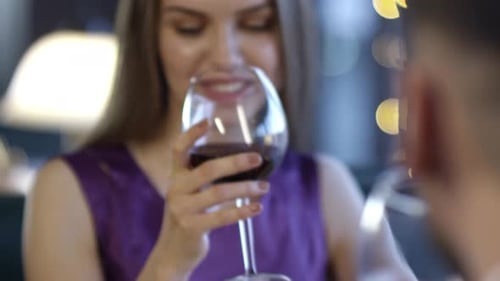 Young Woman Drinking Wine on Date