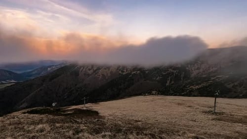 Mountains Shrouded in Clouds During Golden Sunset