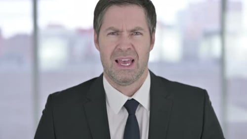 Angry Businessman Yelling in Frustration, Close Up