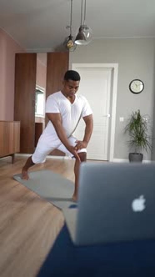 Man Stretching in Living Room During Daytime