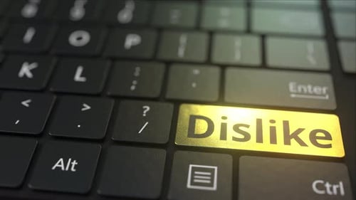 Black Computer Keyboard and Gold Dislike Key