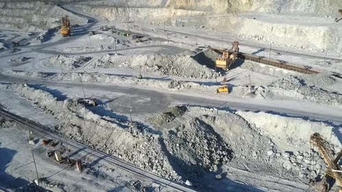 Excavator Loads Platforms for Rock Transportation on Pit