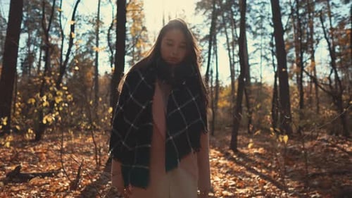 Pretty Young Woman Is Resting in Park in Autumn, Walking on Ground in Sunny Day