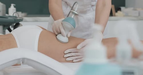 Medical Professional Using Device on Person's Leg
