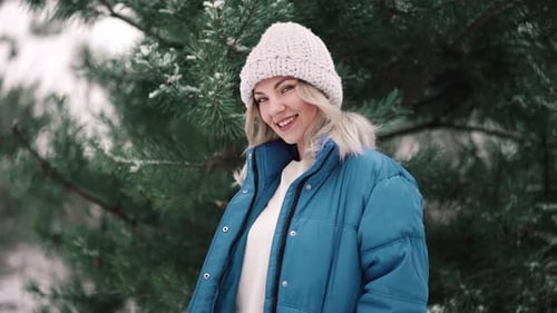 Young Beautiful Woman Posing in Forest During Winter Season