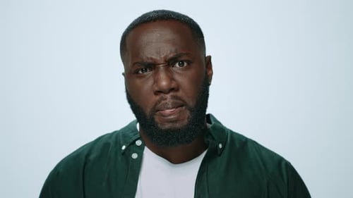 Portrait of Thoughtful African American Man Posing on Grey Background