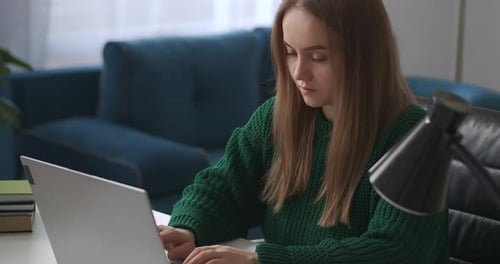 Female Programmer Is Working at Home Typing on Keyboard of Modern Notebook Remote Online Job for