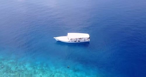 Tropical birds eye abstract shot of a sandy white paradise beach and turquoise sea background