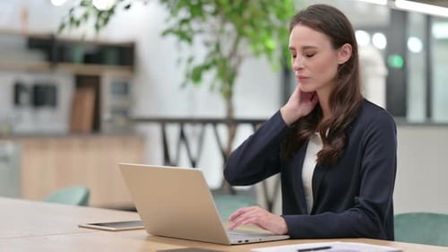 Woman Working on Laptop in Modern Office