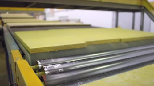 Insulation Boards Moving Along Conveyor Belt