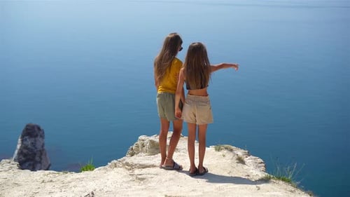 Children on Vacation on White Rock Background