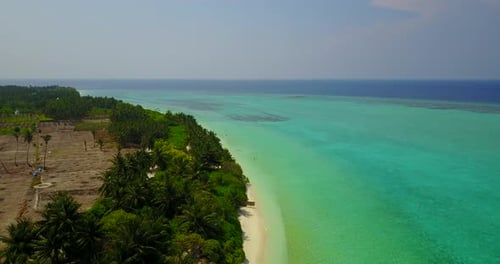 Wide angle overhead abstract view of a sandy white paradise beach and blue ocean background