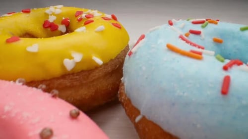 Close Up of Frosted Donuts with Sprinkles