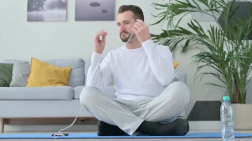 Man Meditating in Living Room