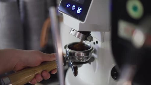 Espresso Grounds Being Dispensed From Grinder