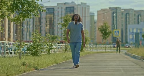 African Walks Through the City He is Happy