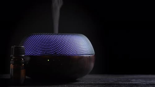 Essential Oil Diffuser on Wooden Table with Dark Background