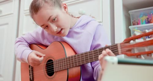 Girl Plays Guitar in Bedroom and Sings