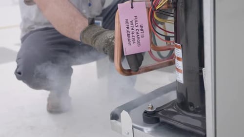 HVAC Technician Servicing Air Conditioning System