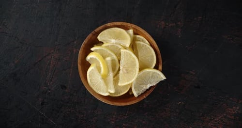Lemon Slices in Wooden Bowl