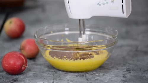 Electric Mixer Mixing Batter in a Clear Glass Bowl
