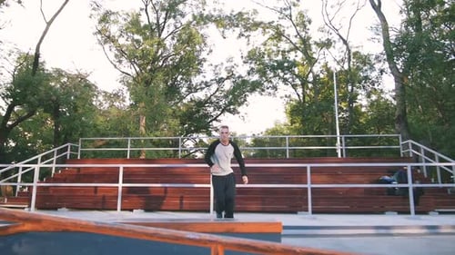 Young Man Doing Parkour Tricks in Extreme Sports Park