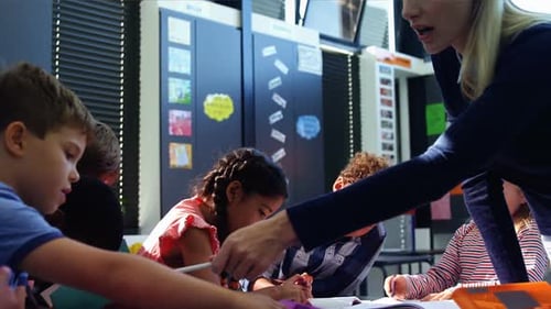 Teacher Helping Students in a School Classroom
